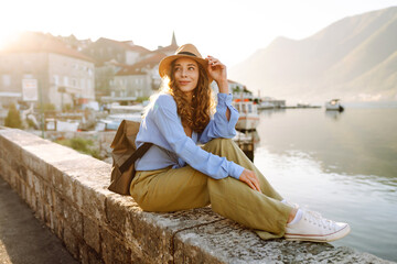 young female tourist enjoys the view of the city. europe travel. lifestyle, vacation, tourism, natur