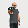 © romankrykh - Man holds modern portable video-photo stabilizer. White background. Vlog and video blog concept.