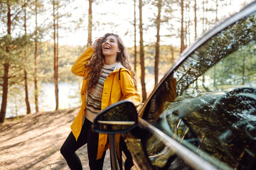 Wall Mural - Female driver enjoying freedom and beautiful nature. The concept of traveling by car, active lifestyle.