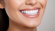 © Elchin Abilov - Close up face of young woman with beautiful smile isolated on grey wall with copy space. Successful multiethnic girl. Latin woman looking at camera against gray wall with a big whitening teeth smile