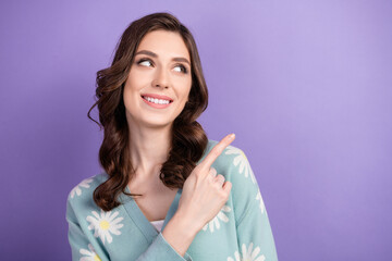 Wall Mural - Portrait of sweet lady dressed blue cardigan pointing finger empty space make presentation instagram isolated on purple color background