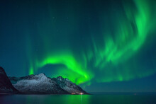 View of mountains range along the fjords coastline with northern light on Lofoten Islands, Nordland, Scandinavia, Norway.