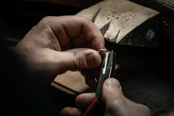 Wall Mural - Jeweler making handmade jewelry on vintage bench. The art of jewelry.