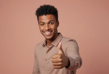 Wall Mural - A young adult male with a bright smile gives a thumbs up to the camera. He's wearing a casual button-up shirt with a coral background.