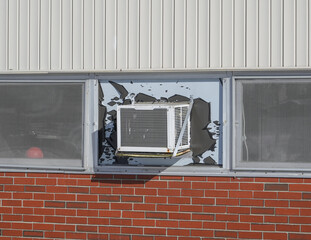 old air conditioner installed on rustic house window