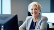 © екатерина лагунова - Mature business woman 65 years old using laptop and working on computer while sitting at desk in office.