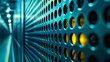 Closeup of a perforated metal surface with a blurred background, featuring a play of blue tones and orange light reflections creating a bokeh effect.