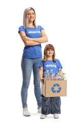 Poster - Full length portrait of a young woman and a child volunteer holding a box with bottles for recycling