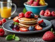 Delicious and homemade mini pancakes as a sweet perfect snack Poffertjes with fruits as sweet breakfast. Homemade Poffertjes with fresh fruit toppings