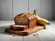 Delicious banana bread served on wooden table on black background. Uniform white background. Savory banana loaf on opposing backdrops