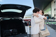 © ADDICTIVE STOCK - Emotional goodbye at the airport with open trunk