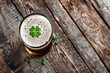 overhead view of a pint of beer with a lucky irish clover. St Patrick's day drink