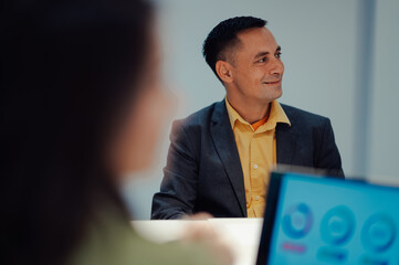 Wall Mural - Middle aged man team leader presenting project to its diverse colleagues