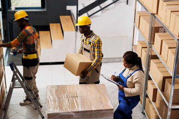 Wall Mural - Package handlers picking order and packing parcels in warehouse. All black retail storehouse employees team inspecting packages before transportation using checklist on clipboard top view