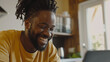 © Sophie  - Happy black man on his laptop. African american male working remotely from home. Inclusive and diverse workplace. Flexible and positive culture. AI generated