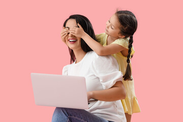 Sticker - Little girl covering her working mother's eyes on pink background