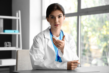 Canvas Print - Female doctor video chatting with patient in office