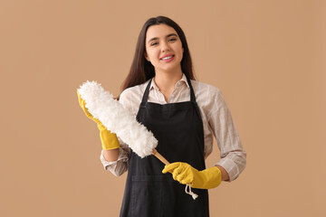 Sticker - Young woman with pp-duster on beige background