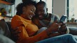 © Generative AI - Happy young woman and man hugging using smartphone together sitting on cozy couch at home smiling overjoyed wife and husband looking at phone screen sitting on sofa in modern living ro : Generative AI