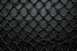 Black metal mesh on a black background.