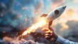 © sirisakboakaew - Businessman-controlled rocket is launching and soaring from hand into the sky for growing business, fast business success, and startup business concept.