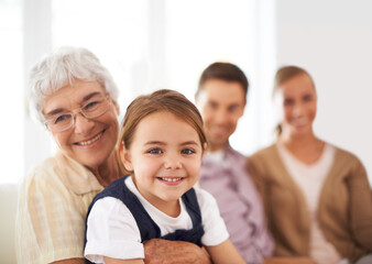 Canvas Print - Portrait, family and happy kid with grandmother in home for bonding, love or care together with parents. Face, grandma and girl child with mother and father in living room with smile for connection