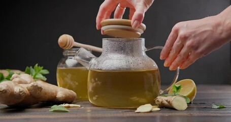 Wall Mural - steaming glass kettle with organic herbal tea