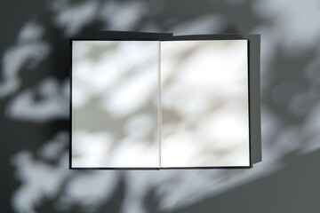 Canvas Print - Blank open notepad on gray background studio shot