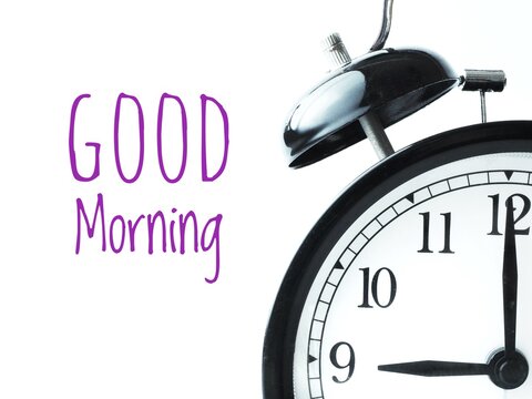 Good morning concept. Classic alarm clock at 9am and Good Morning handwritten text  on a white background