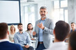 © AspctStyle - Confident Business Leader Giving a Presentation to Colleagues in a Modern Office. Corporate Communication