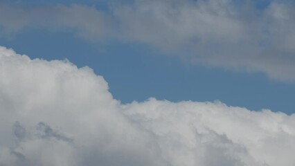 Wall Mural - Movement of beautiful clouds in the blue sky, time lapse video. Nice nature background for your projects.