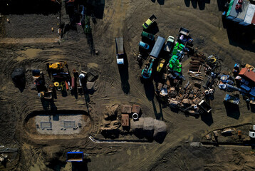 construction site with many machines. construction of houses and schools with purchases of bricks and insulation boards for security in advance. fluctuations in the prices of construction works