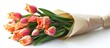 A bouquet of tulips is wrapped in brown paper, ready to be presented or gifted.