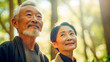 Japanese or Chinese senior pair in bamboo grove, outdoors, wearing jackets, radiant day.