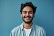 Smiling confident young adult arab man standing isolated on blue background. Happy ethnic guy student or professional employee wearing shirt looking at camera posing, Generative AI