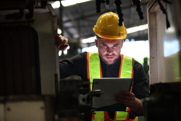 Wall Mural - worker or engineer working in factory with safety uniform , safety hat and safety glasses , image is safety concept or happy workplace