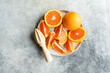 Freshly Cut Oranges with Wooden Juicer on a Plate