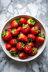 Sticker - Bowl of red strawberries with green leaves on them.