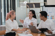 © Parichat - Businesspeople working together on new project in modern office. Teamwork concept.