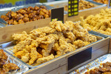 Fototapeta Paryż - Trays of Golden Fried Chicken at a Food Market