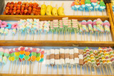 Fototapeta Paryż - Colorful Candy Skewers at a Market Stall