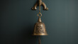 Brass bell with rope pull hanging on wall.
