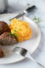 Wall Mural - Mashed potatoes with sweet potatoes on a plate with meatballs. Homemade cooked meal