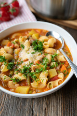 Wall Mural - Minestrone with vegetables, beans, pasta, bacon and parmesan cheese on a plate