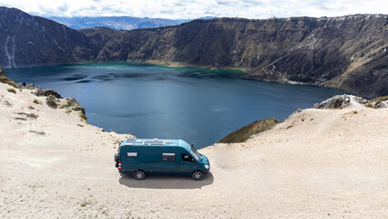 Wall Mural - View of a campervan on the edge of a crater filled with water