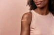 Black woman with band-aid post-vaccination. Generative AI