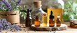 © AkuAku - A collection of various skincare items including bottles of essential oils and lavender flowers displayed on a table.
