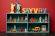 3D rendering of colorful plastic toy cityscapes with famous monuments on red background.