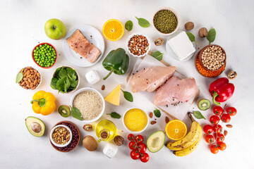 Wall Mural - Clean Eating Diet foods background, fruits, vegetables, lean proteins, whole grains and healthy fats, nuts, legumes, chicken meat, fresh fish, beans on white background. Balanced healthy flat lay