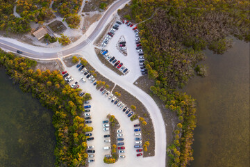 Wall Mural - Parking lot at Florida Blind Pass beach on Manasota Key, USA. Vehicle parking area with cars parked on ocean beach parking lot. Summer vacation on beachfront